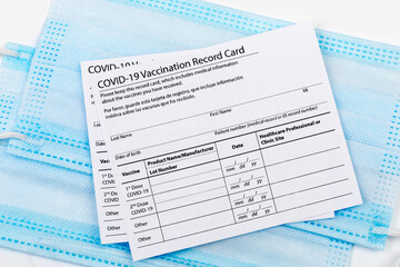 Coronavirus vaccination record card. Protective mask divided into two parts. Concept of defeating Covid-19 - Image