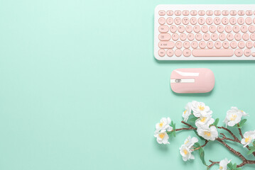 Feminine workspace of office worker, freelancer or blogger. Keyboard, mouse and decorative cherry...