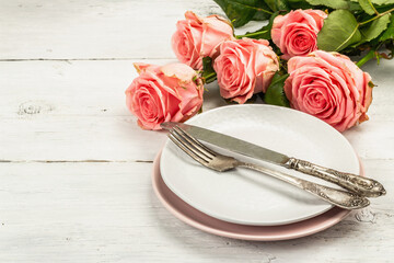 Romantic dinner table on white wooden background. Love concept for Valentine's or Mother's day