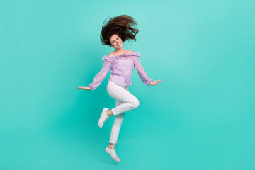 Full size photo of pretty adorable girl flying hair good mood free time isolated on turquoise color...