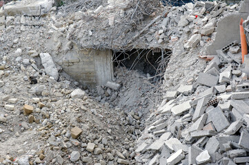 Bricks, stones, breezeblocks, and reinforced concrete of a collapsed building. 