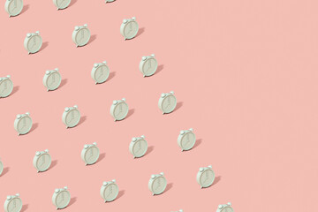 The pattern is made of brightly lit green alarm clocks on a pink background. Abstract trendy business layout with copy space in pastel colors. 3d render.
