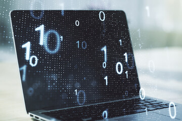 Double exposure of creative abstract binary code hologram on laptop background. Database and programming concept