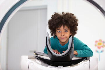 A boy in a magnetic resonance imaging machine in a hospital.