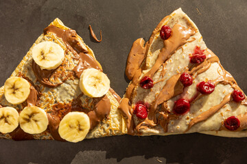 European pancakes with chocolate cream, cherries and bananas