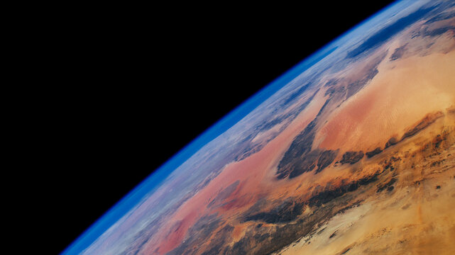 Earth horizon photo from outer space on a black background, The Libyan Desert on a closeup planet earth image, wide high resolution horizontal photo of world. Elements of this image furnished by NASA.