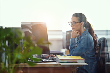 Shes a diligent worker. Cropped shot of a businesswoman working at her desk.