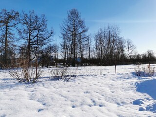 winter day in the Russian village snow well blue sky