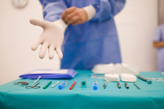 Doctor preparing for a surgery with his instruments in front of him