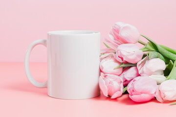 Fototapeta na wymiar Closeup of mockup mug with pink tulips, spring concept