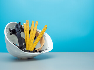 White construction helmet and construction tools.
