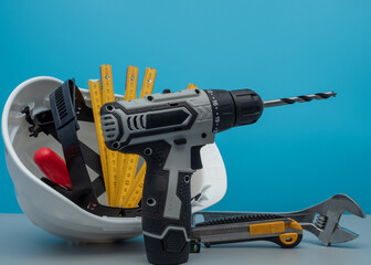 White construction helmet and construction tools.