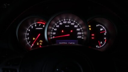 Car dashboard during start engine on the darkness