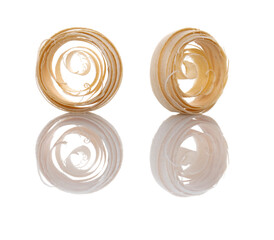 Wood shavings set on a white isolated background with reflection. The shavings together with the...