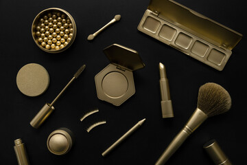 luxury cosmetics - set with golden decorative makeup products on black background. top view