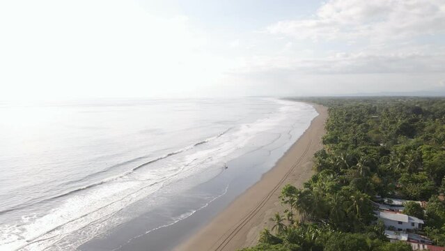 The long, sandy coastline of Damas island on the west coast of Costa Rica. Fast aerial orbit