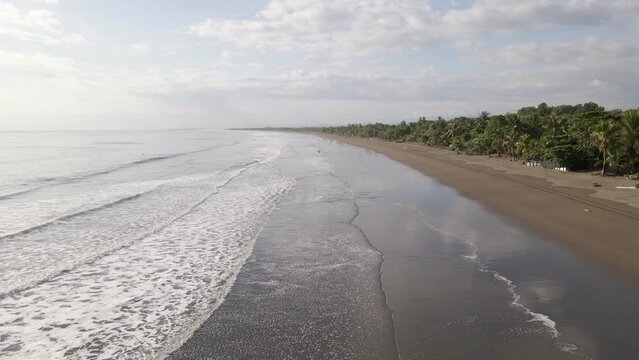 The long and empty coastline of Damas Island on Costa Rica's pacific west coast. Low flying backwards tracking shot