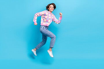 Full size photo of funny millennial brunette lady run wear pullover jeans footwear isolated on blue background