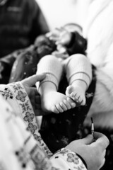 The sacrament of the baptism of a child in an Orthodox church, the priest anoints the baby's feet...