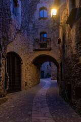 Fototapeta na wymiar typical cobbled street of the town of pals in the spanish costa brava at night