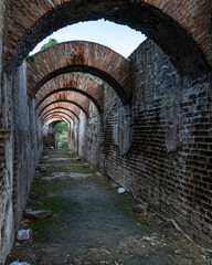 A scenic ancient pathway with arches at Baia archaeology park near Naples, Campania region, Italy