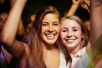 Having the time of their lives. Young girls in an audience enjoying their favourite bands...