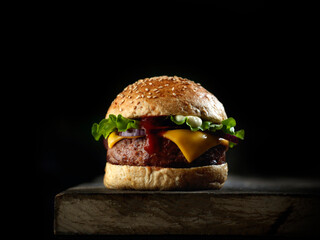 Fresh tasty burger on black background