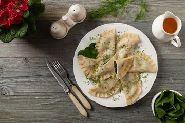 Dumplings with spinach, topped with melted butter and sprinkled with chopped dill
