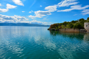 Fototapeta premium Blue sky, lake and trees. Lake Ohrid in North Macedonia
