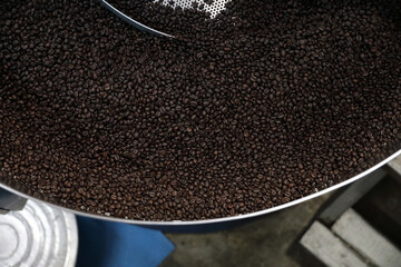 Coffee beans roasting with machine in close up