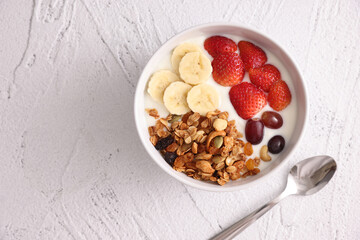 bowl of granola cereal with yogurt and berries isolated on white background