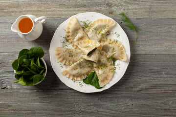 Dumplings with spinach, topped with melted butter and sprinkled with chopped dill