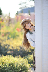 A beautiful woman in lolita dress in garden background Japanese street fashion portrait