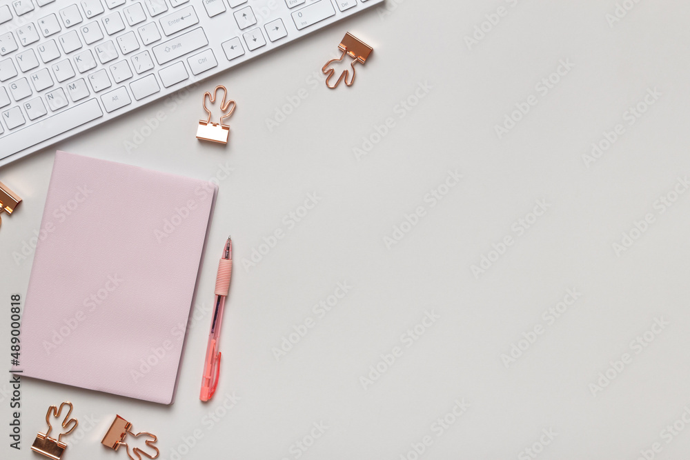 Poster desktop. notepad keyboard pen paper clips on the table. top view flat lay copy space
