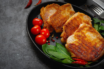 Grilled pork steaks in a pan with spices with copy space