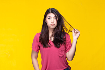 Fototapeta premium Image of feeling excited, shock, surprise and happy. Young asian woman standing on yellow background. Female face expressions and emotions body language concept.