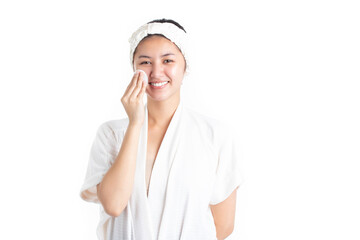 Attractive beautiful natural woman cleaning makeup from her face with cotton pad smile and looking at camera isolated on white background. Skin care and beauty concept.