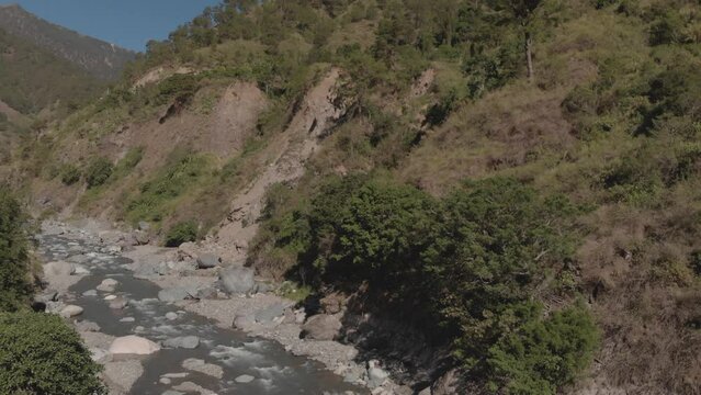 Mountain river flowing in mountain valley surrounded green trees rocks still aerial wide angle Kabayan Benguet Philippines
