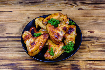 Pile of the roasted chicken wings on plate