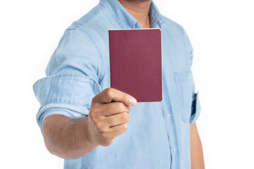 Handsome young man holding passport isolated on white background.