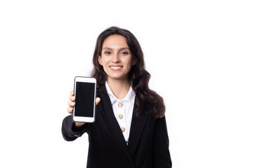 Fototapeta premium Portrait confident young attractive business woman. Confident young manager wearing black suit looking friendly showing blank telephone isolated on white background. Business woman concept.