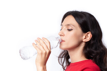 Beautiful young woman wearing red shirts are drinking water refreshing in the morning isolated on white background.