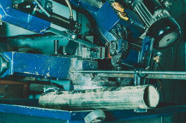 Machine for cutting metal pipes. The cutting process. Metal dust. Industry.