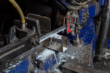The process of cutting metal pipes. Metalworking. Metal dust.