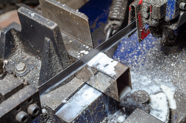 Working process of cutting metal pipes in the production shop. Close.