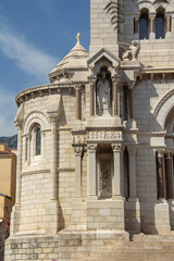 Detail of the outer walls of the church Cathedral of the Immaculate Conception Monaco. At the end on the roof are the symbols of the Evangelists. Romanesque Catholic Cathedral 