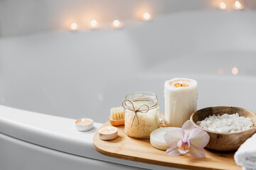 Preparation for hotel spa treatment or home bath procedure. White washbasin in bathroom with...