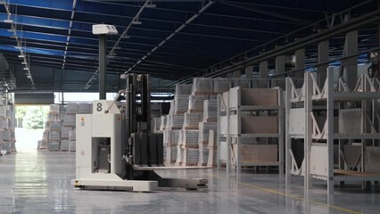 Modern production, automatic robot loader moves among the racks, logistics warehouse in the production of a tile factory