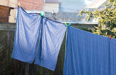 bedsheets hanging on clothesrack outdoors