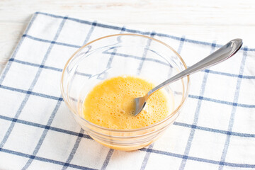 Whisking eggs in a glass bowl.